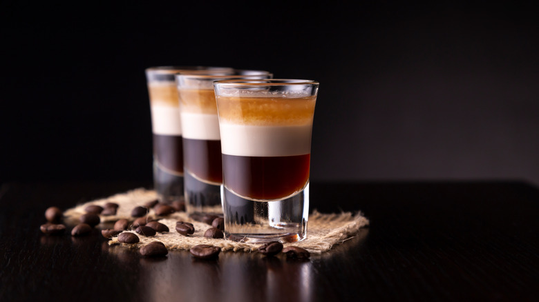 Three shots of layered B-52s sitting on burlap and surrounded by coffee beans