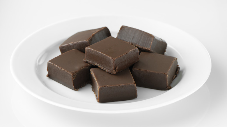 Chocolate fudge squares on white plate