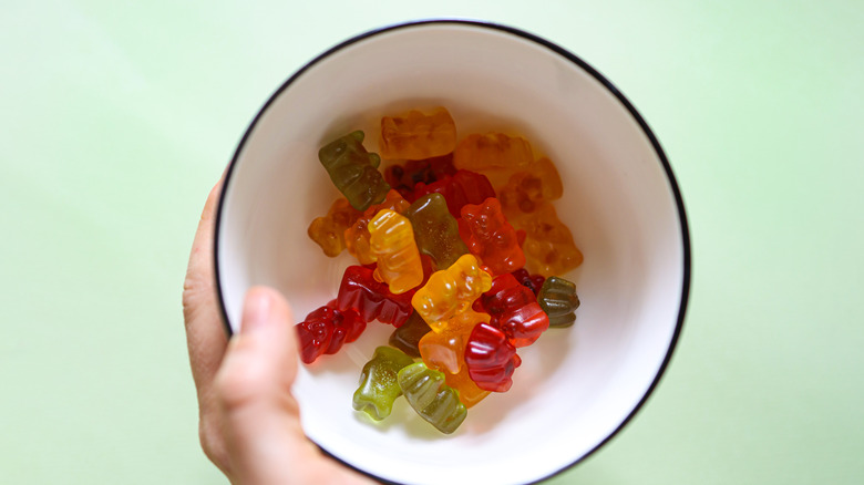 Person holding bowl of gummy bears