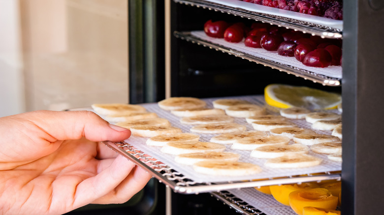 Hand pulling out tray of food