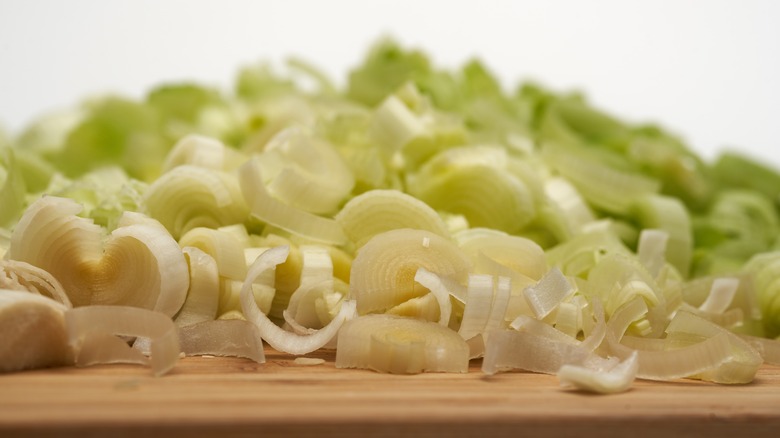 Close up of chopped leek on a wooden chopping board