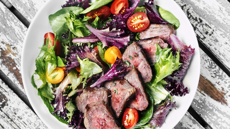 steak salad in white plate