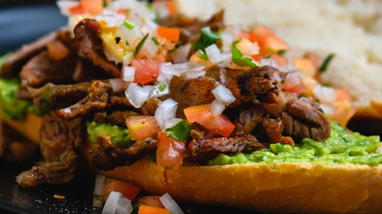 steak guacamole and salsa open sandwich