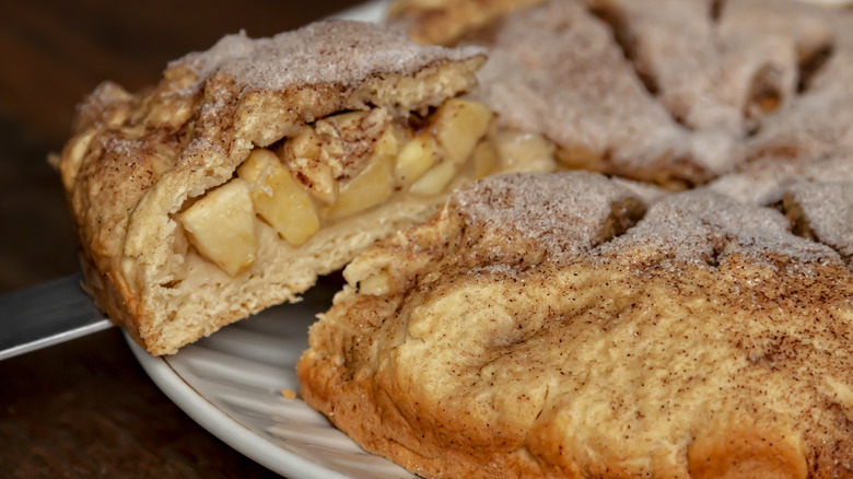 Slice of apple pie lifted off plate