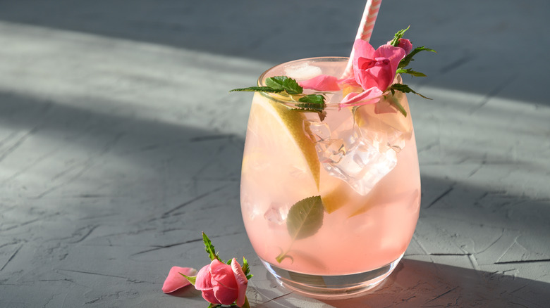 Glass of iced lemonade with roses