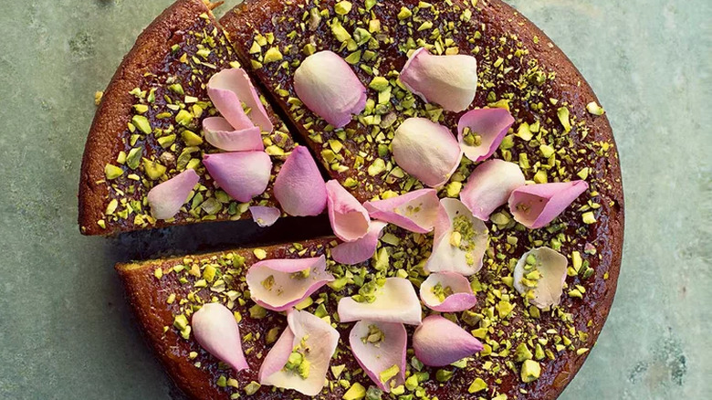 Cake covered in pistachios and rose petals