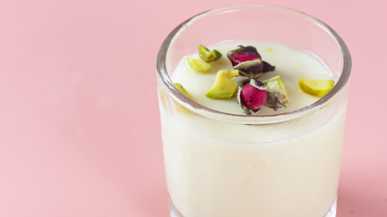 Glass of mahalabiya with roses and pistachios