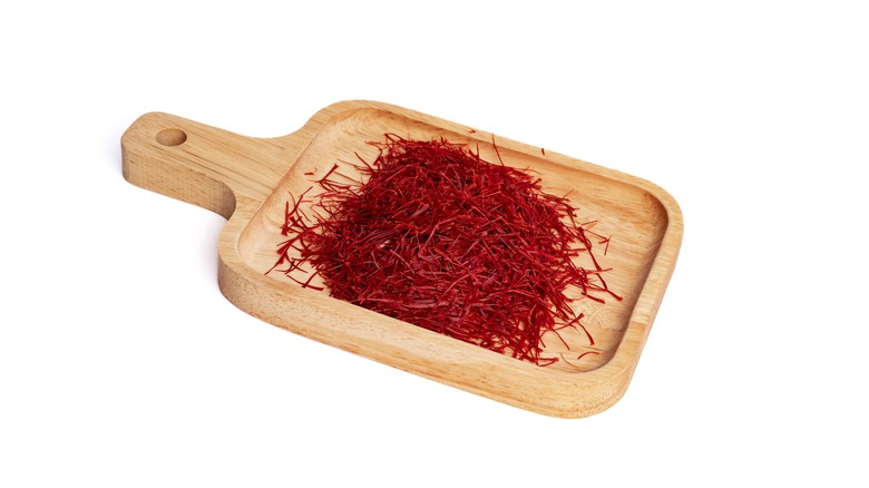 closeup of saffron strands on wooden board