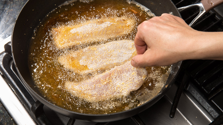 Fish fillets in bubbling oil