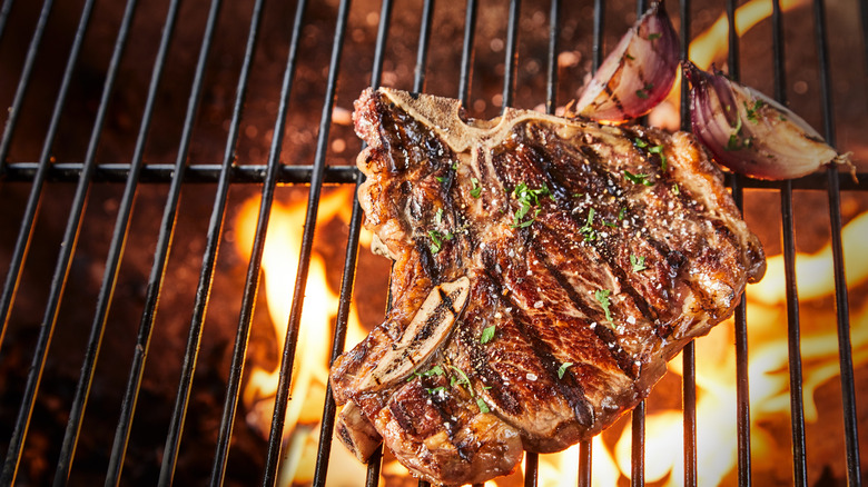 Grill marks on steak above coals