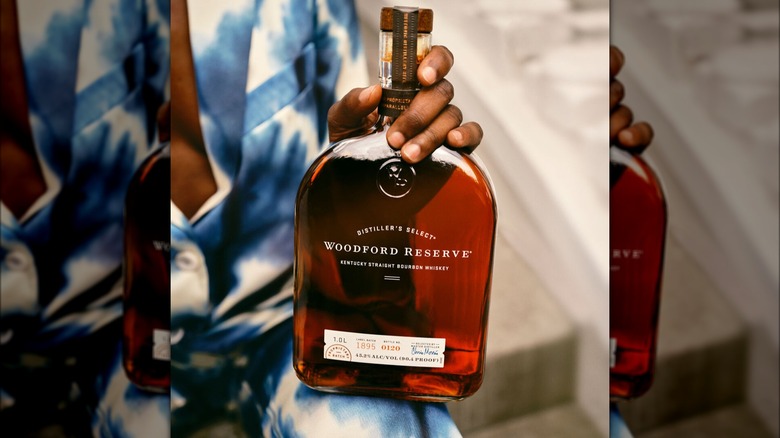 Woman holding a bottle of Woodford Reserve