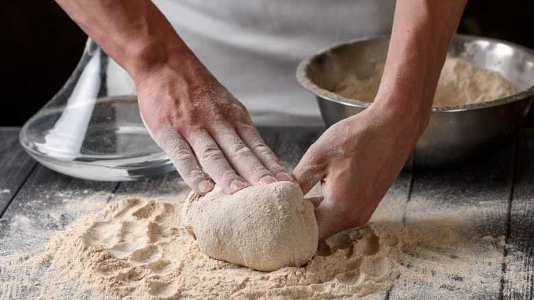 Person mixing dough on counter