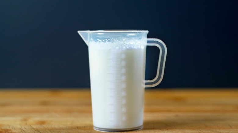 Milk in measuring glass