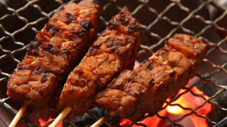 Skewered tempeh on a grill