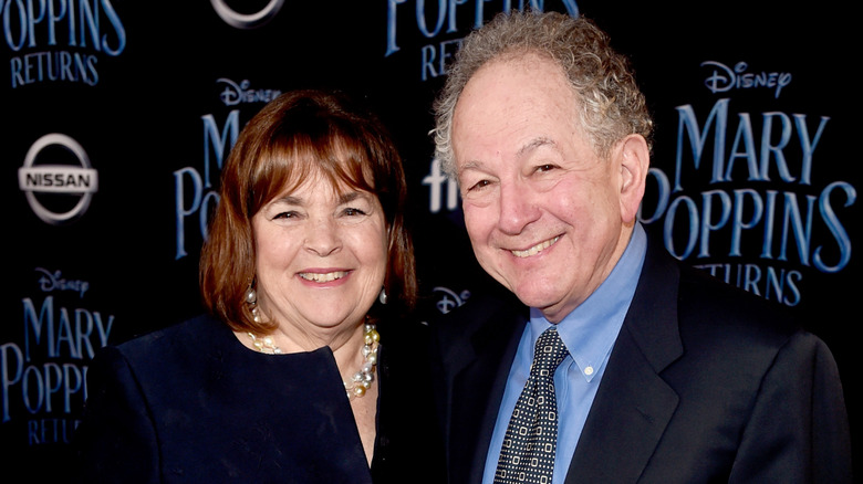 Ina Garten and Jeffrey Garten standing together and smiling on red carpet