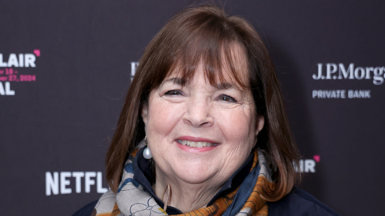 Ina Garten smiling against red carpet background