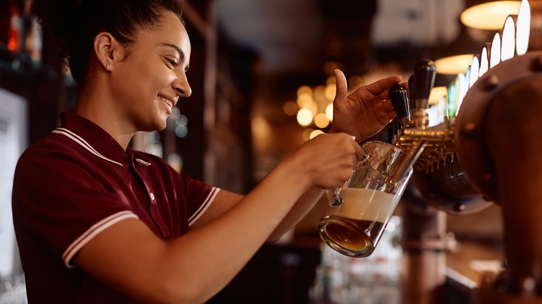 Woman pouring draft beer