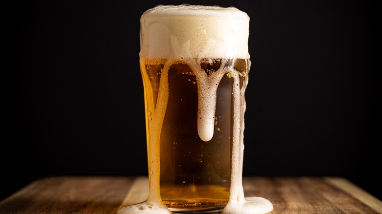 Beer glass with overflowing head