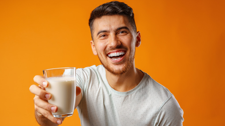 man holding glass of milk