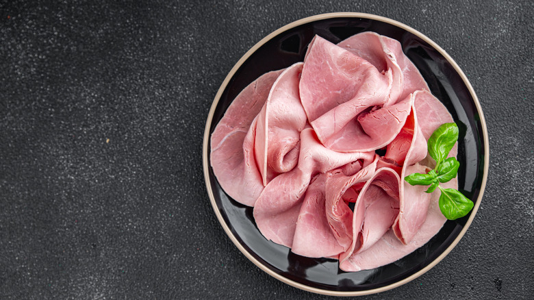 Bologna meat on a dark background