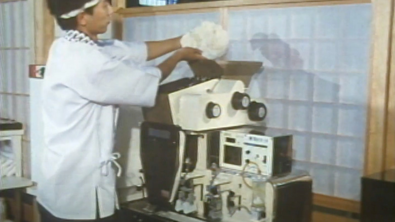 Chef loading sushi rice into world's first nigiri machine