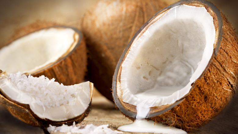 open coconut with milk dripping out