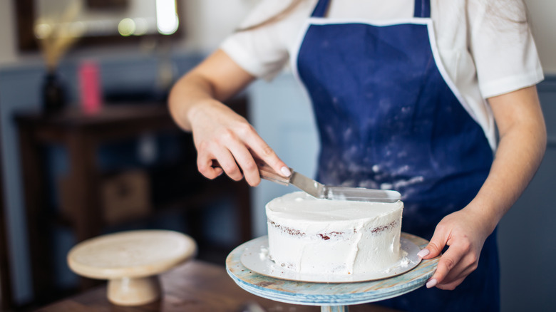 Woman frosting a cake