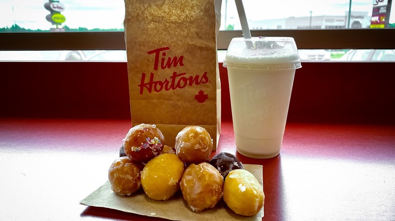 Glazed Timbits with a milkshake on a table at Tim Hortons