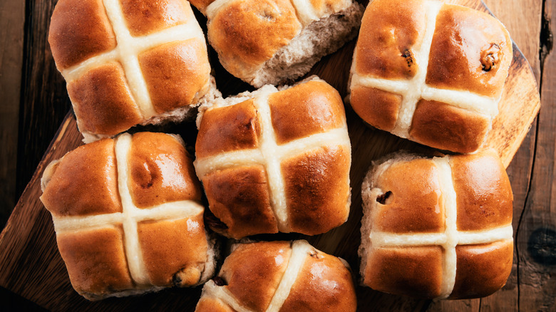 Hot cross buns on wooden board