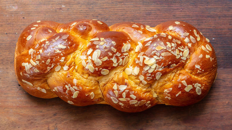 Loaf of Greek tsoureki bread, topped with flaked almonds