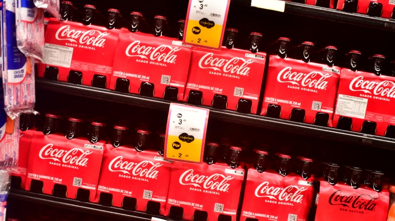 Coke bottles for sale on shelf