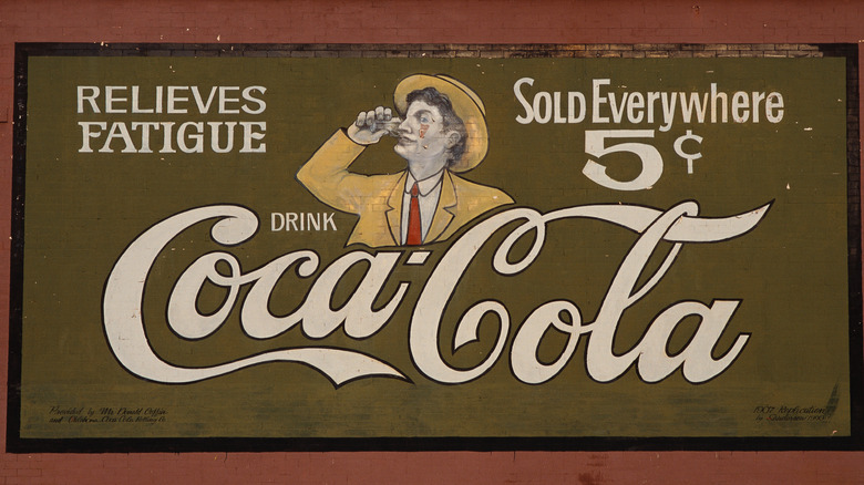 old coca-cola ad on wall