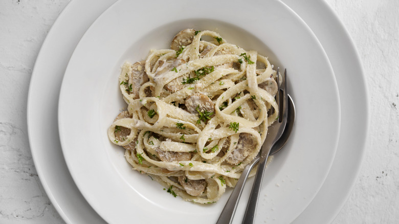 bowl of fettuccine on white plates