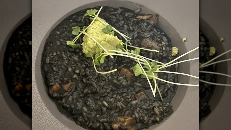 Black risotto in a grey bowl