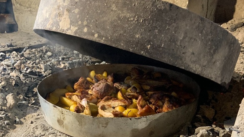 Meat cooking in a peka pan