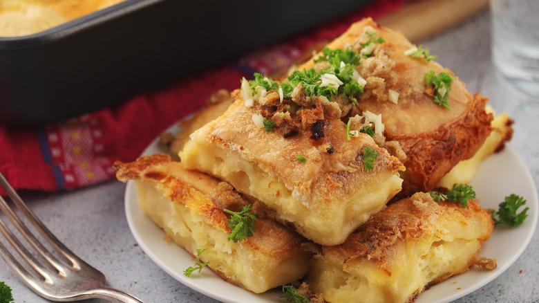 Blocks of baked cheese on plate