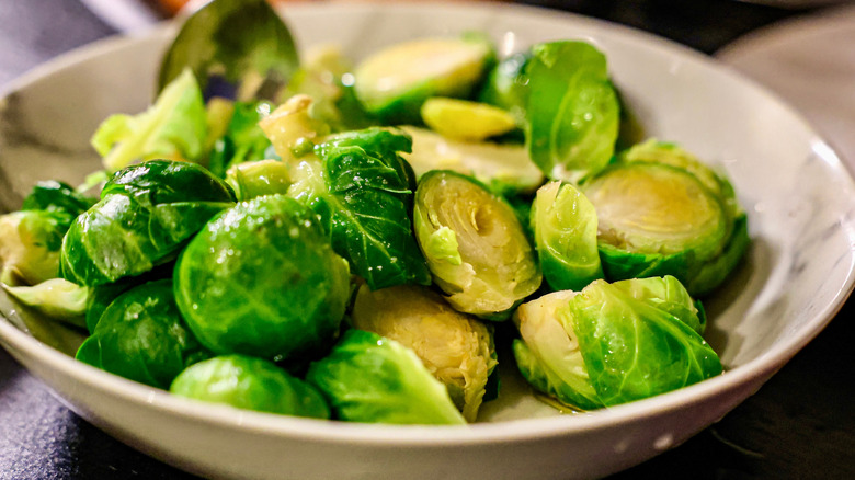 Halved cooked Brussels sprouts in dish