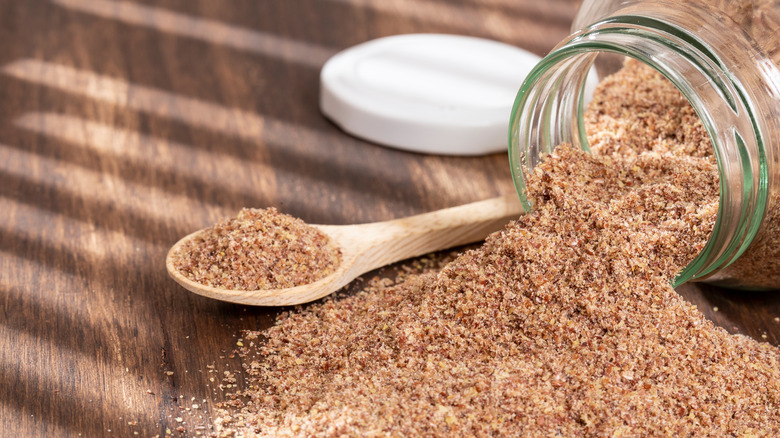 Ground flaxseed spilling from jar