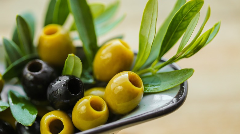 Dish of olives and olive leaves