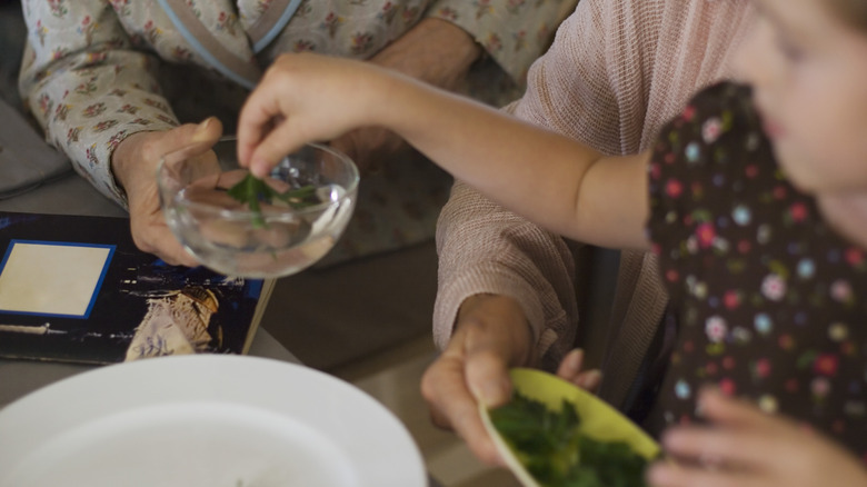 Dipping parsley in saltwater