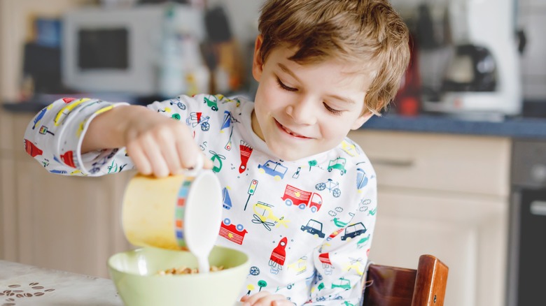 pouring milk into cereal