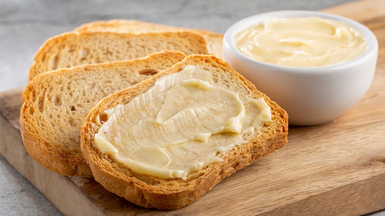 Buttered toast on cutting board