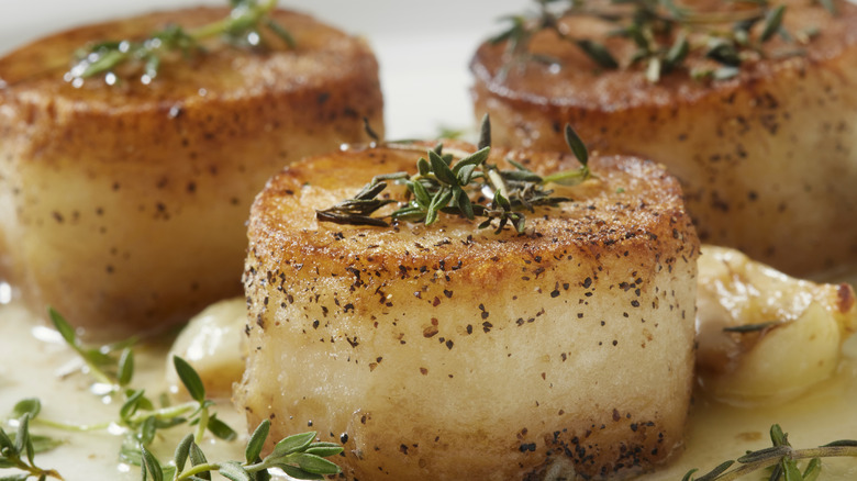Fondant potatoes garnished with thyme