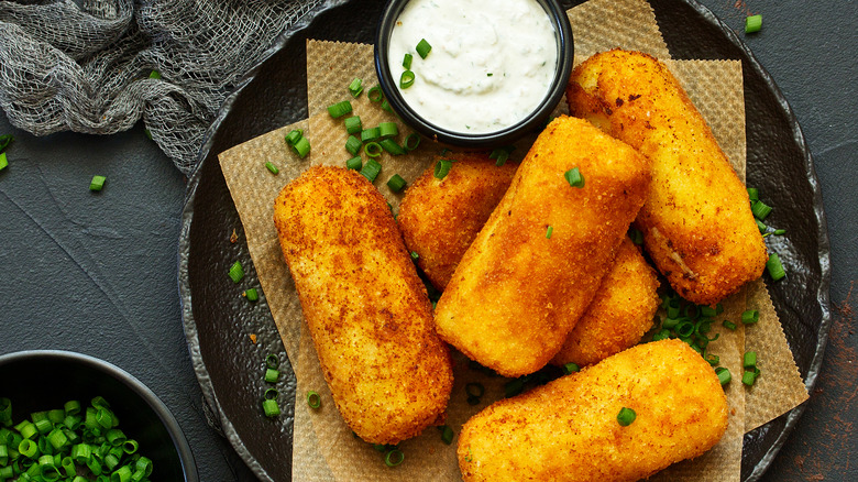 Potato croquettes next to dip