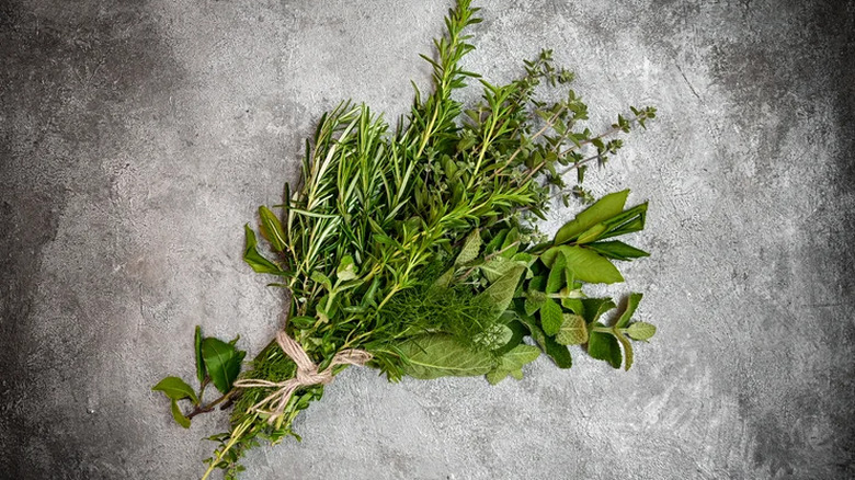 bunch of fresh herb sprigs tied together with twine