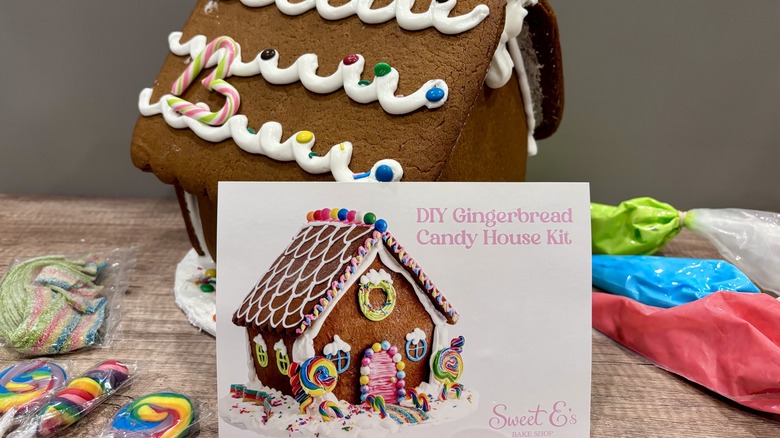 Sweet E's Gingerbread House surrounded by decorating ingredients