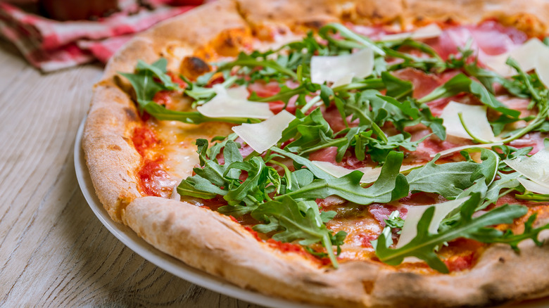 Pizza topped with fresh arugula