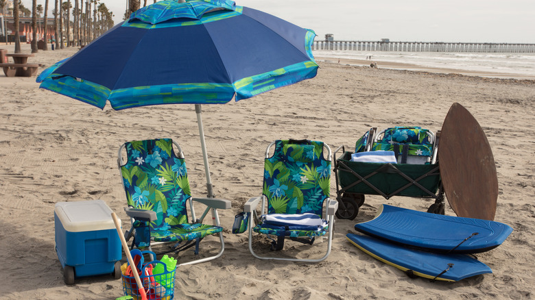 cooler shaded by beach umbrella