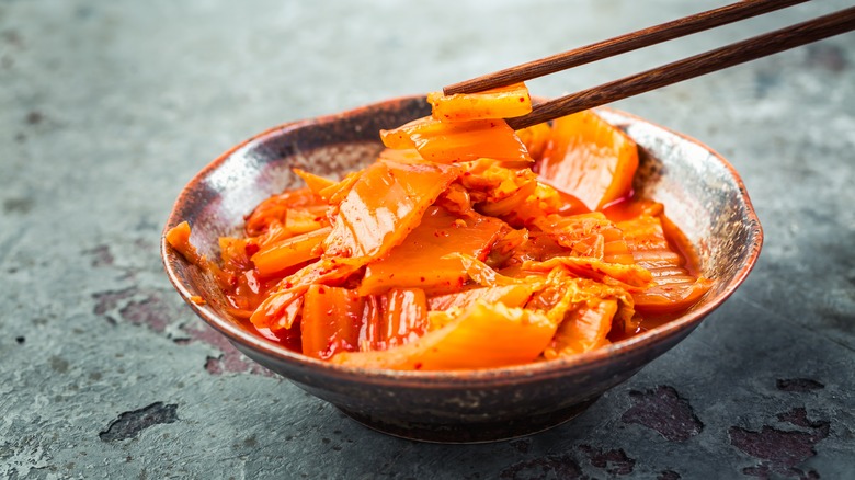 kimchi in bowl with chopsticks 