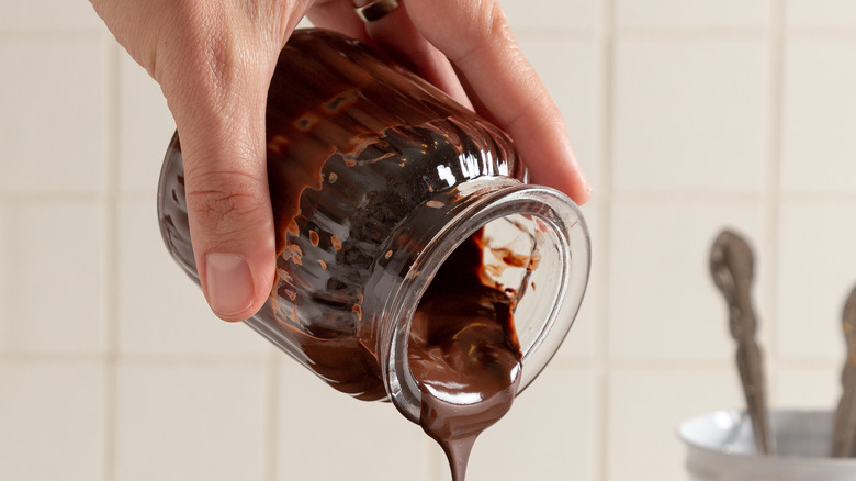 chocolate sauce flowing from jar